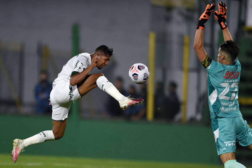 O atacante Rony, do Palmeiras, toca na bola para encobrir o goleiro Unsain, do Defensa Y Justicia pela Recopa Sul-Americana. Foto: Marcelo Endelli/AFP